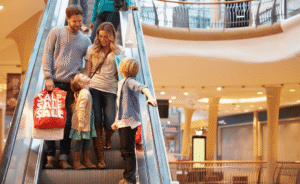 family coming down an escalator together